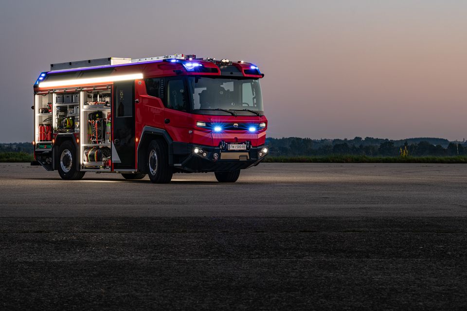 RT: Full lighting open storage compartments Side view of the RT at dusk with open storage compartments and full lighting.